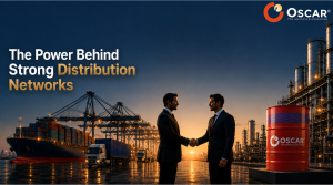 Two businesspeople shake hands at a port with cranes, ships, and oil barrels; the banner reads 'The Power Behind Strong Distribution Networks' with the OSCAR logo.